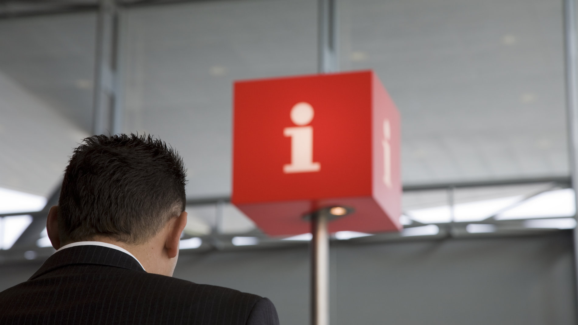 A man stands in front of an information counter